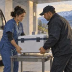 Health workers coordinate the transport of a medical container.