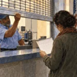 Conceptual painting of a postal worker closing a public service window.