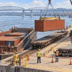 Painted illustration of workers moving goods among barge, rail and truck.